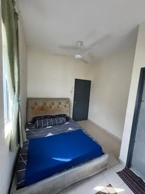 a bedroom with a blue bed in a room at A&M Homestay Prima Bagan Serai in Bagan Serai