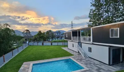 a house with a large yard with a swimming pool at Galaxy Homestay in Ipoh