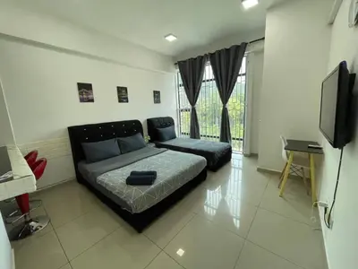 a bedroom with a bed and a flat screen tv at GR studio APARTMENT 2 - kompleks MUTIARA gua MUSANG in Gua Musang
