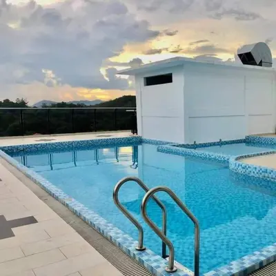 a large swimming pool with blue water at GR studio APARTMENT 2 - kompleks MUTIARA gua MUSANG in Gua Musang