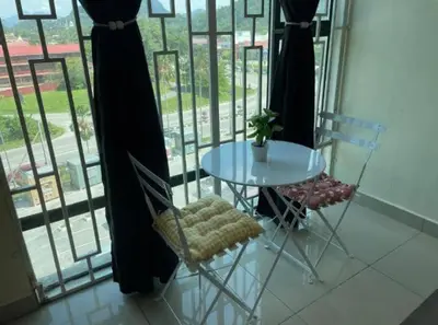 a table and chairs in a room with a window at GR studio APARTMENT 3 - kompleks MUTIARA gua MUSANG in Gua Musang
