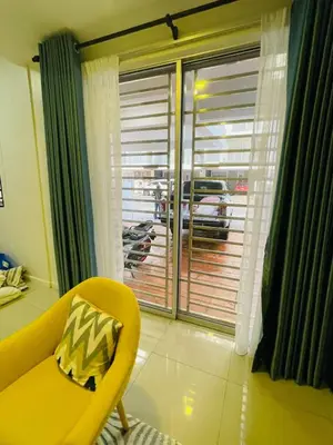 a yellow chair in a room with a window at The Grand Crystal Retreat 4-Bedroom Luxury Villa in Taiping