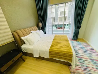 a bedroom with a bed with a large window at The Grand Crystal Retreat 4-Bedroom Luxury Villa in Taiping