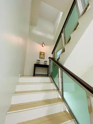 a staircase in a house with glass railing at The Grand Crystal Retreat 4-Bedroom Luxury Villa in Taiping