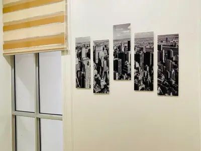 a wall with four pictures of cities on it at The Grand Crystal Retreat 4-Bedroom Luxury Villa in Taiping