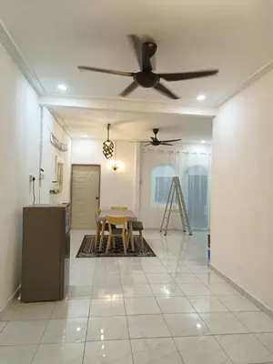 a living room with a table and a ceiling fan at AR Homestay SP TRJ in Sungai Petani