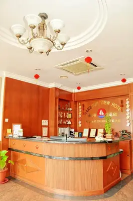a bar in a restaurant with a chandelier at Harbour View Hotel Sekinchan in Sekincan