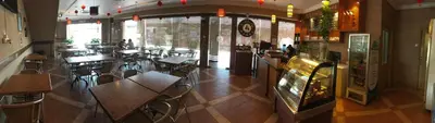 a restaurant with tables and chairs in a room at Harbour View Hotel Sekinchan in Sekincan