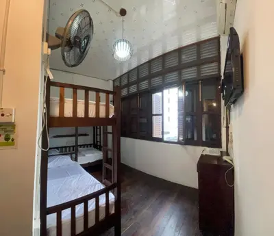 two bunk beds in a room with a window at Pearl Heritage Homestay in George Town