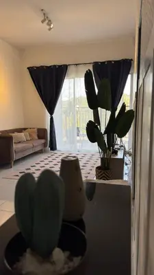 a living room with a potted plant and a couch at DADDY HOMES 4 EMERALD AVENUE CENTRUM Brinchang View in Brinchang