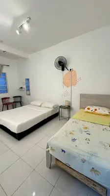a bedroom with two beds and a fan at DADDY HOMES 4 EMERALD AVENUE CENTRUM Brinchang View in Brinchang