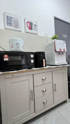 a kitchen counter with a microwave and appliances on it at DADDY HOMES 4 EMERALD AVENUE CENTRUM Brinchang View in Brinchang