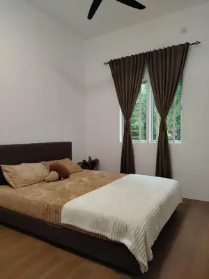 a bedroom with a large bed and a window at Risfeena Home in Sekincan
