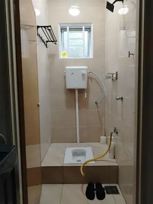 a bathroom with a shower with a toilet in it at Risfeena Home in Sekincan