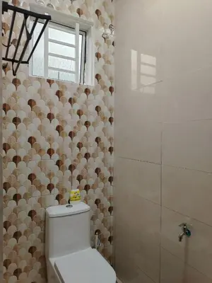 a bathroom with a toilet and a shower at Risfeena Home in Sekincan