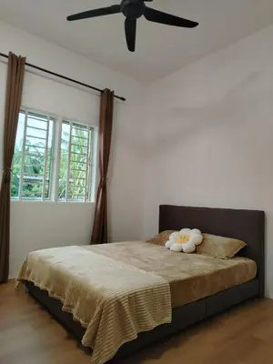 a bedroom with a bed with a ceiling fan at Risfeena Home in Sekincan