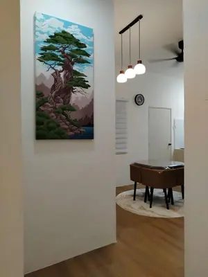 a room with a table and a painting on the wall at Risfeena Home in Sekincan
