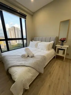 a bedroom with a large bed with a large window at Modern Two Bedroom Ipoh City Apartment with Pool, Gym and Free Parking in Ipoh