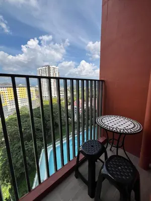 a balcony with a table and two stools and a table at Modern Two Bedroom Ipoh City Apartment with Pool, Gym and Free Parking in Ipoh