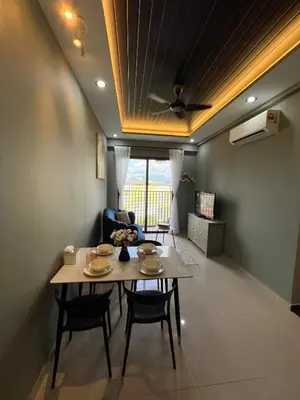 a dining room with a table and chairs and a ceiling at Modern Two Bedroom Ipoh City Apartment with Pool, Gym and Free Parking in Ipoh