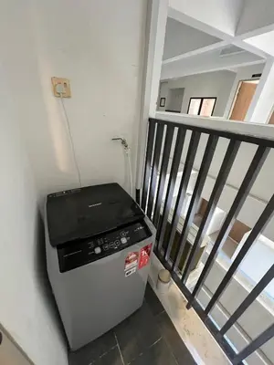 a small stove in a room next to a staircase at Modern Two Bedroom Ipoh City Apartment with Pool, Gym and Free Parking in Ipoh