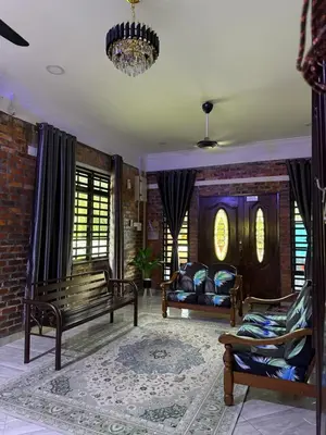 a living room with benches and a brick wall at Homestay Anjang in Tapah