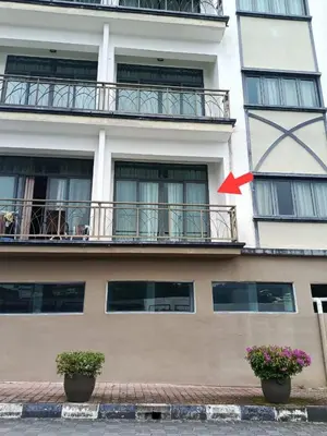 a building with two potted plants in front of it at Bayt Rizq Homestay 3R2B in Brinchang