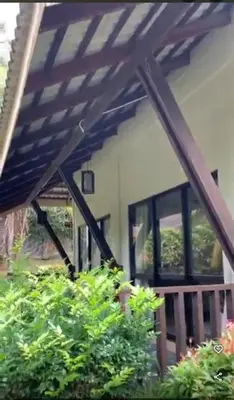 a view of a house with a wooden pergola at Eds Hot Spring Villa's in Sungkai