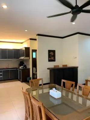 a dining room and kitchen with a table and chairs at Eds Hot Spring Villa's in Sungkai