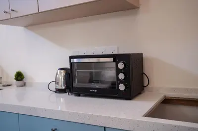 a microwave sitting on top of a kitchen counter at Georgetown Heritage 1F stay 10pax 3BR in George Town