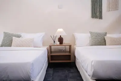 two beds sitting next to each other in a room at Georgetown Heritage 1F stay 10pax 3BR in George Town