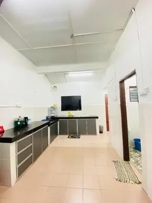 an empty room with a desk and a tv at Homestay Sayang in Ipoh