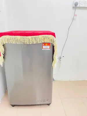 a table on top of a metal trash can with a red counter at Homestay Sayang in Ipoh