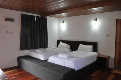 two beds sitting next to each other in a room at Joe Fisherman Inn in Pangkor