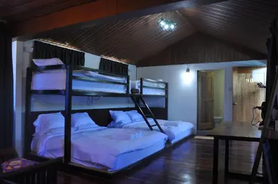 a bedroom with two bunk beds in a room at Joe Fisherman Inn in Pangkor