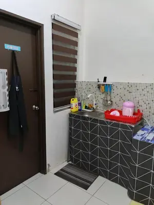 a kitchen with a counter with a sink in it at Seri Homestay Apartment Seri Iskandar in Seri Iskandar