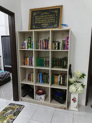 a book shelf filled with books in a room at Seri Homestay Apartment Seri Iskandar in Seri Iskandar