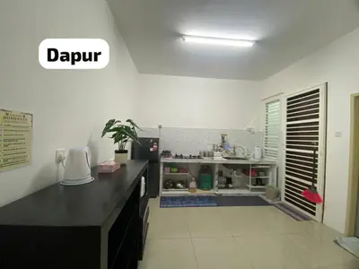 a kitchen with a black counter top in a room at Chinta Homestay in Kampong Ayer Melintas Besar