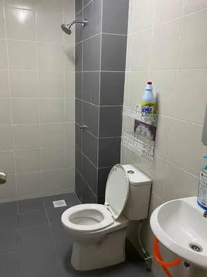 a bathroom with a toilet and a sink at Chinta Homestay in Kampong Ayer Melintas Besar