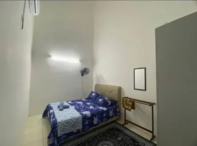 a small bedroom with a bed in a room at Chinta Homestay in Kampong Ayer Melintas Besar