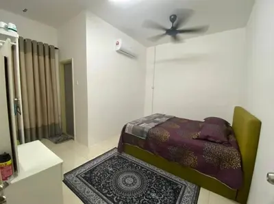 a bedroom with a bed and a ceiling fan at Chinta Homestay in Kampong Ayer Melintas Besar