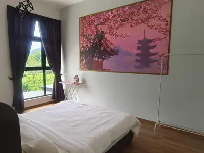 a bedroom with a bed and a painting on the wall at The Cove Signature Hillside Ipoh by MW in Ipoh