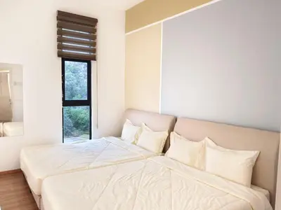 a bedroom with a large bed with white sheets and pillows at The Cove Signature Hillside Ipoh by MW in Ipoh
