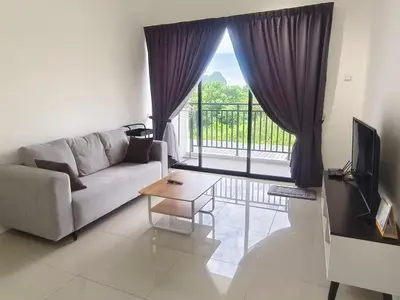 a living room with a couch and a table and a window at The Cove Signature Hillside Ipoh by MW in Ipoh