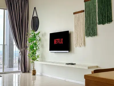 a living room with a tv on a wall at Taiping High Floor 3BR Home for 12 Guests with Coway Free WiFi and Netflix in Taiping