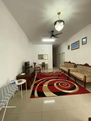 a living room with a couch and a rug on the floor at HSKeladanImpian in Gua Sai