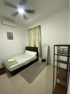 a bedroom with a bed and a ceiling fan at HSKeladanImpian in Gua Sai