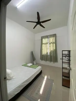 a bedroom with a bed with a ceiling fan at HSKeladanImpian in Gua Sai