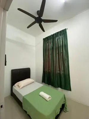 a bedroom with a bed with a ceiling fan at HSKeladanImpian in Gua Sai