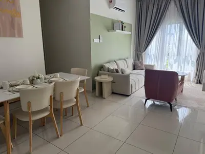 a living room with a table and a couch at The Horizon Ipoh by Amris in Ipoh